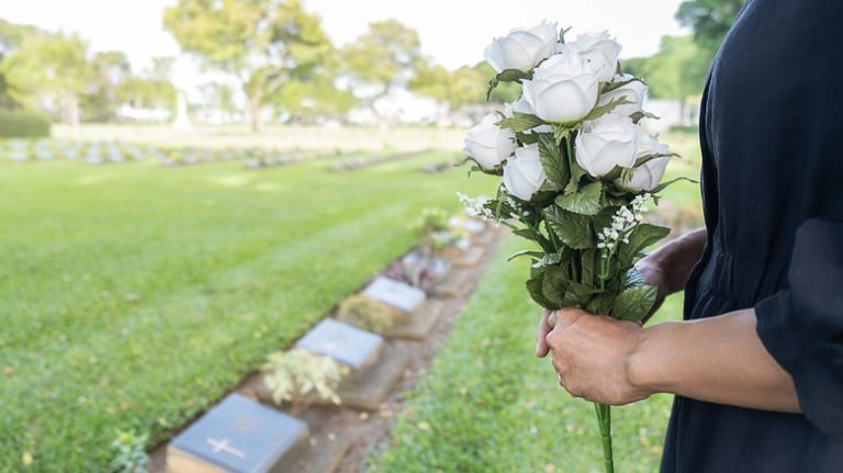 woman visiting parent in cemetery