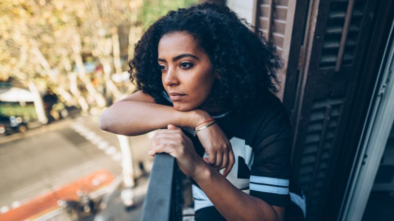 depressed woman staring out the window