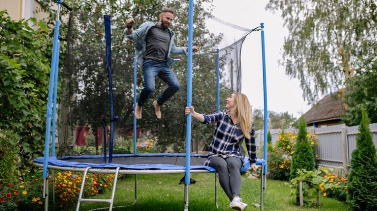 Two adults on a trampoline