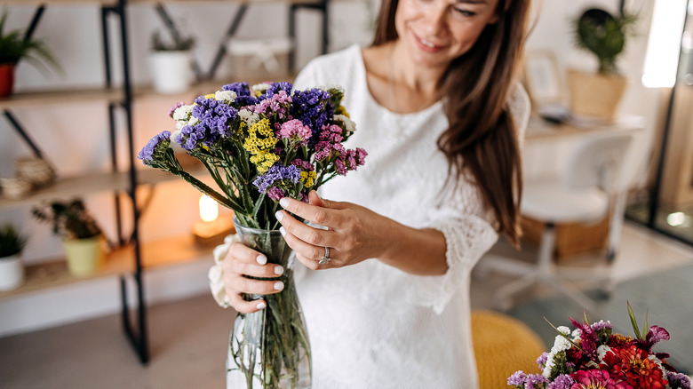 Woman arranging flower bouquet