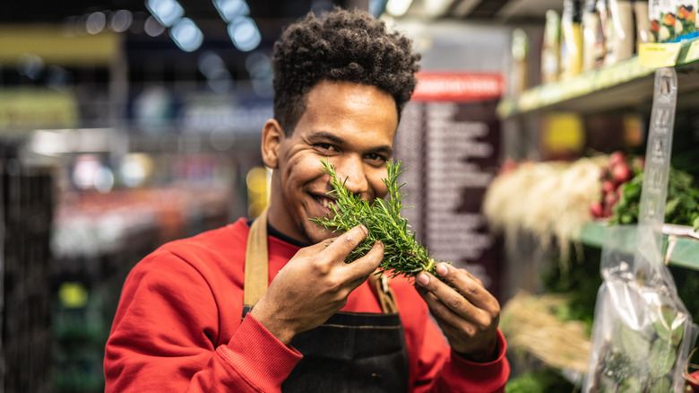 store clerk holds rosemary