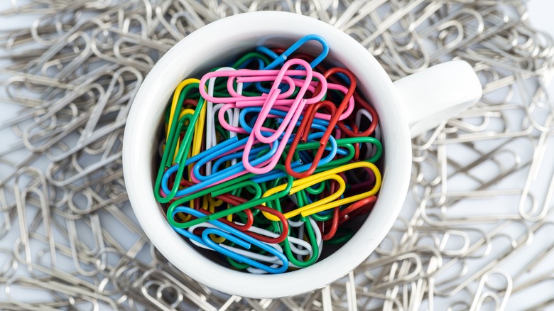cup filled with colorful paperclips