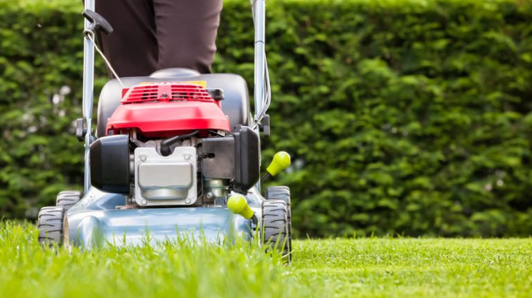 lawn mower moving across lawn