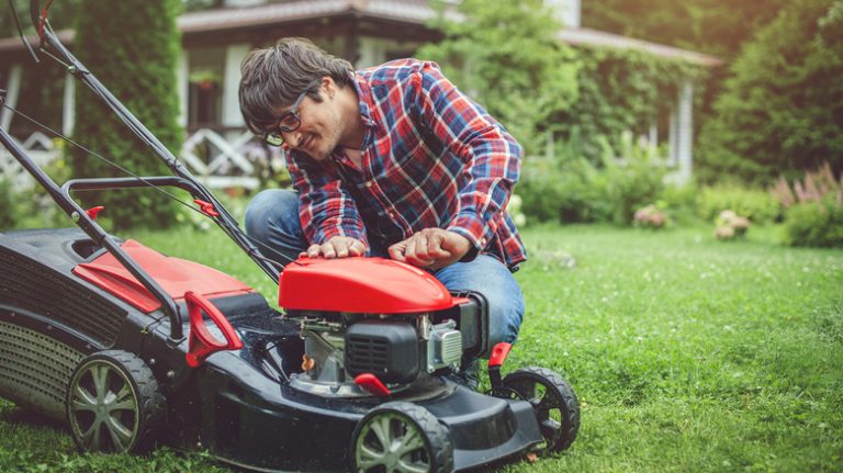 man fixing lawnmower