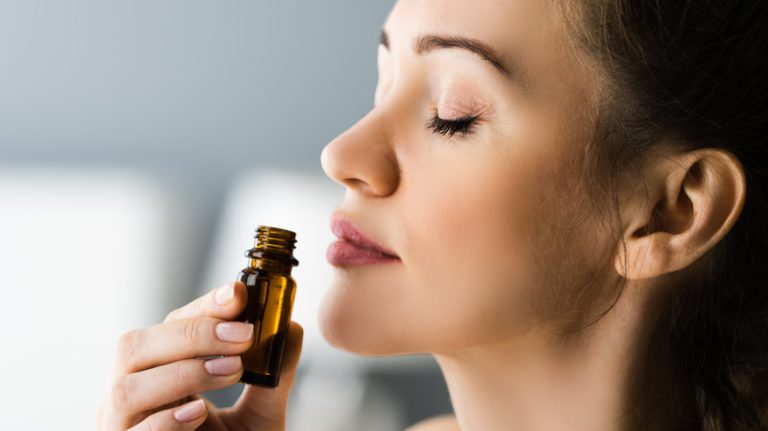 woman smelling essential oils