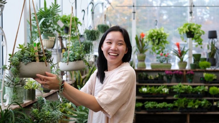 Smiling woman inside greenhouse