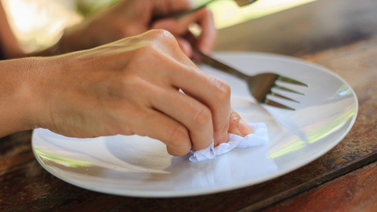 Woman polishing white plate