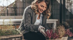 woman tending to fall plants
