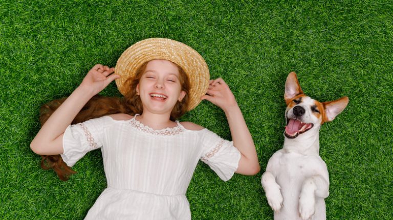 Girl and puppy on a lawn